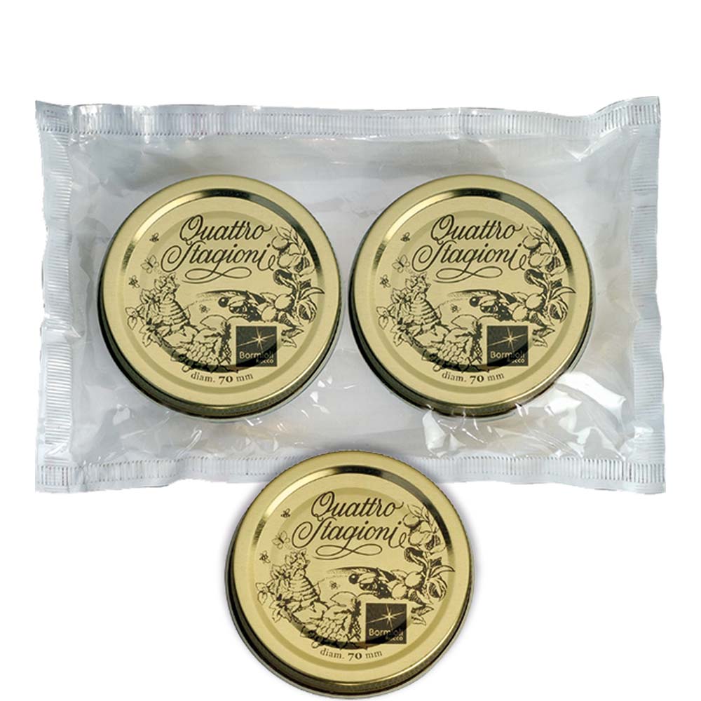 Drei goldene Deckel in Verpackung.