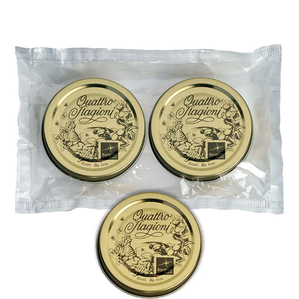 Drei goldene Deckel in Verpackung.