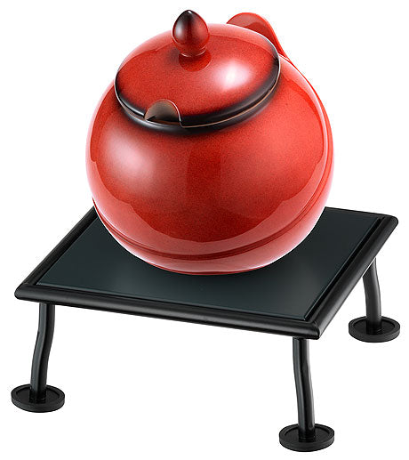 Roter Topf auf schwarzem Ständer.