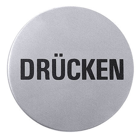 Runder Knopf mit "Drücken"-Aufschrift.