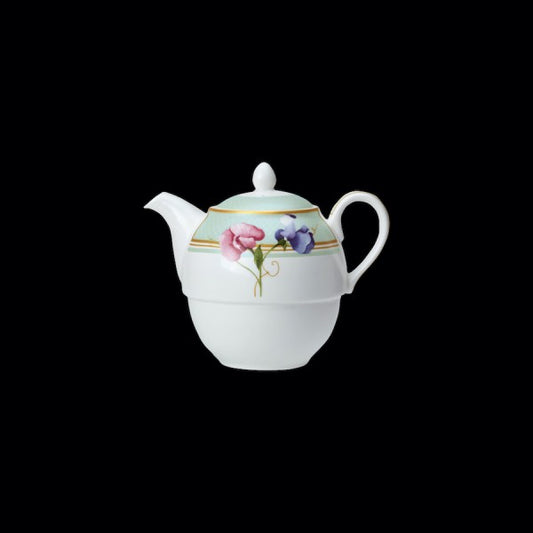 Teekanne mit Blumenmuster auf Schwarz.