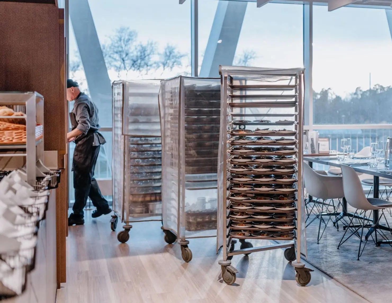 Rollwagen mit Tabletts in Restaurantküche.