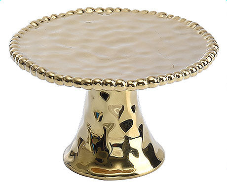 Goldener Tortenständer mit Muster.