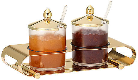 Goldenes Marmeladenset mit Löffeln.