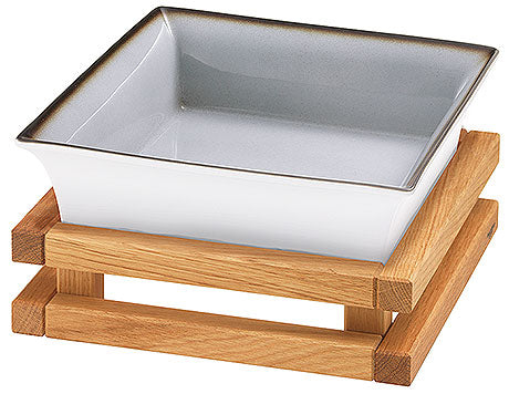 Weiße Schale auf Holzgestell.